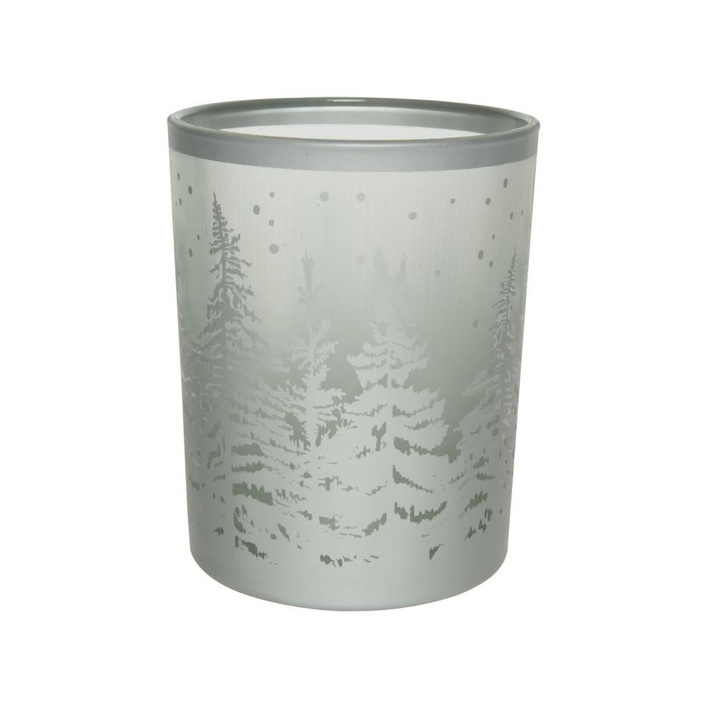 A frosted glass candle holder featuring a snowy forest scene with tall pine trees.