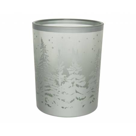 A frosted glass candle holder featuring a snowy forest scene with tall pine trees.