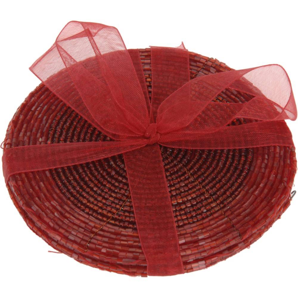 A round woven basket in warm red tones, elegantly tied with a sheer red ribbon.