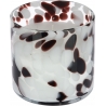 A round candle holder with a swirling pattern of black and white spots on a translucent background.