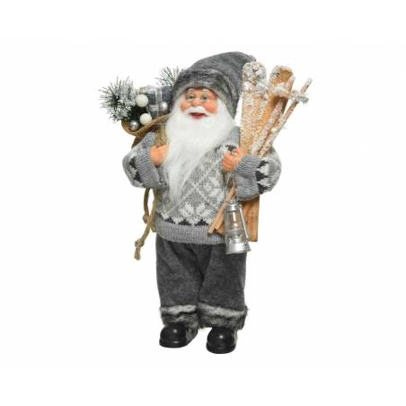 A cheerful Santa in gray attire, holding skis and a lantern, adorned with winter greenery.