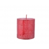 A cylindrical red candle with a textured surface and a single wick on top.