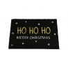 A black doormat with "HO HO HO" in gold and "MERRY CHRISTMAS" in white, surrounded by stars.