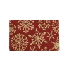 A festive red mat adorned with golden snowflake patterns.