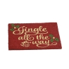 A festive red doormat with golden cursive text and green holly accents.