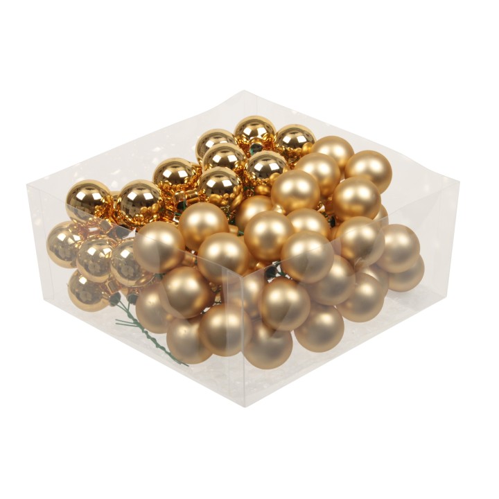 Gouden kerstballen in een doorzichtige doos, met glanzende en matte afwerkingen.