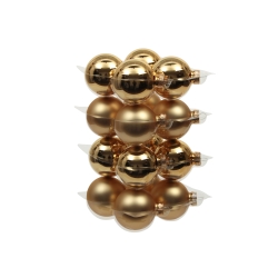 A stack of shiny gold Christmas ornaments, smooth and reflective, creating a festive display.