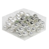 A collection of shiny silver and white pearls arranged in a clear, hexagonal container.