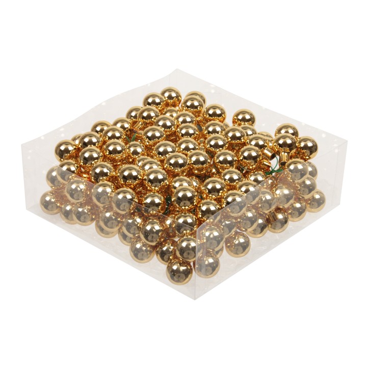 Glanzende gouden balletjes in een doorzichtige verpakking, speels en feestelijk.