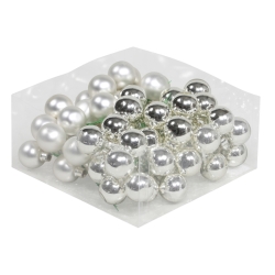 A collection of shiny silver and white decorative beads in a clear container.