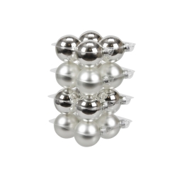A stack of shiny silver and metallic ornaments arranged in a neat, tiered display.