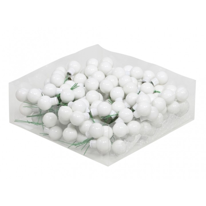 Witte bolletjes met groene steeltjes, op een doorzichtige ondergrond, in een stapel gepresenteerd.