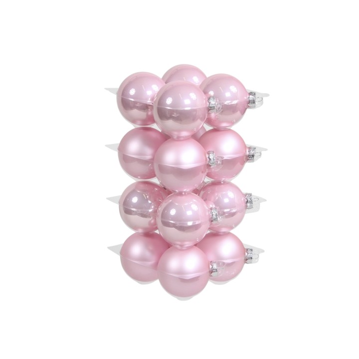 Een stapel glanzende, roze kerstballen met verschillende tinten en een ronde vorm.