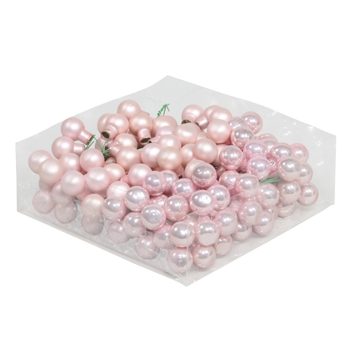 Een stapel glanzende, roze en parelmoerachtige kralen in diverse maten.