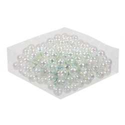 A pile of shiny, iridescent plastic pearls on a clear surface, reflecting light beautifully.