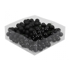 A clear container holds glossy, black spherical grapes, creating a striking contrast.