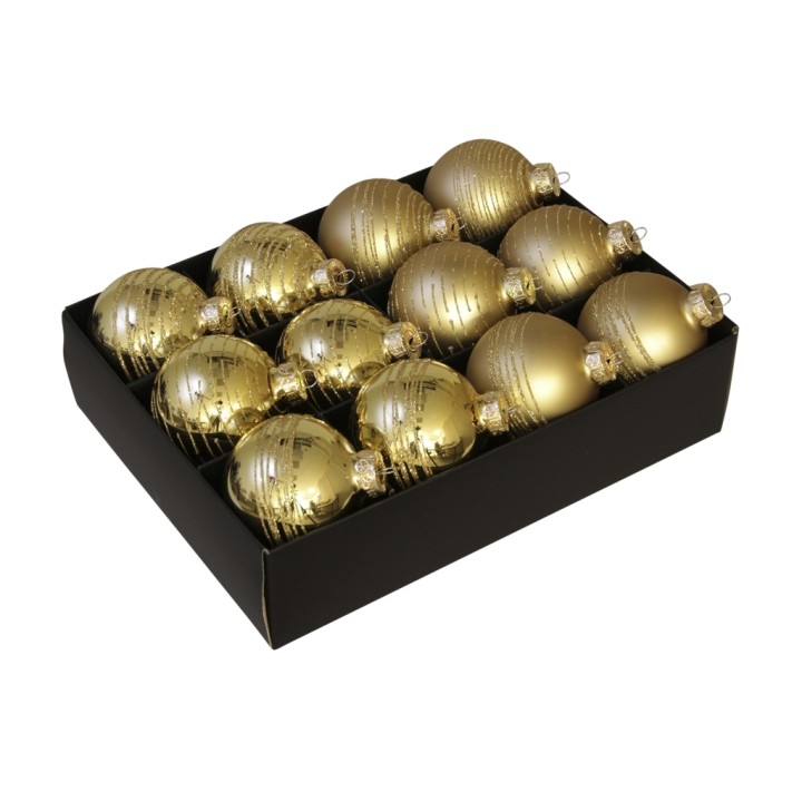 Gouden kerstballen in een zwarte doos, glanzend met een gestreept patroon, elegant en feestelijk.