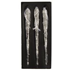 Three delicate, clear glass icicles with textured surfaces, elegantly displayed on a black backgr...