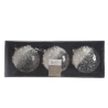 Three round, frosted glass ornaments with a glittery finish, presented in a sleek black box.