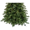 A lush green artificial Christmas tree adorned with warm white lights.