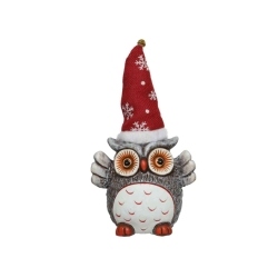 A whimsical owl figurine wearing a red snowflake-patterned hat.