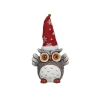 A whimsical owl figurine wearing a red snowflake-patterned hat.