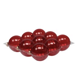 Glanzende, dieprode glazen bollen in een speelse, gestapelde opstelling op een metalen oppervlak.