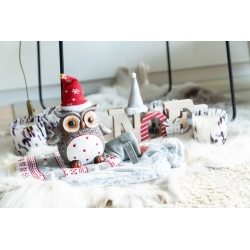 A cozy holiday scene with a festive owl, soft textures, and cheerful decor elements.