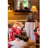 Cozy holiday scene with red and white decor, a plush chair, and festive accents.