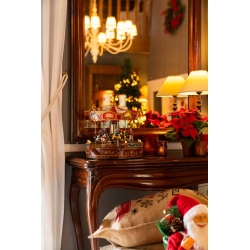 A festive scene with a vintage carousel, warm lights, and holiday decorations.