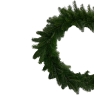 A lush green wreath made of pine branches, full and circular in shape.