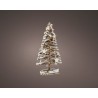 A snowy, star-adorned Christmas tree with a rustic wooden base, softly glowing.