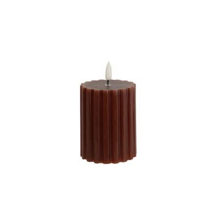 A tall, ribbed candle in deep brown with a small white wick on top.