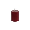 A textured, cylindrical red candle with a small white wick on top.