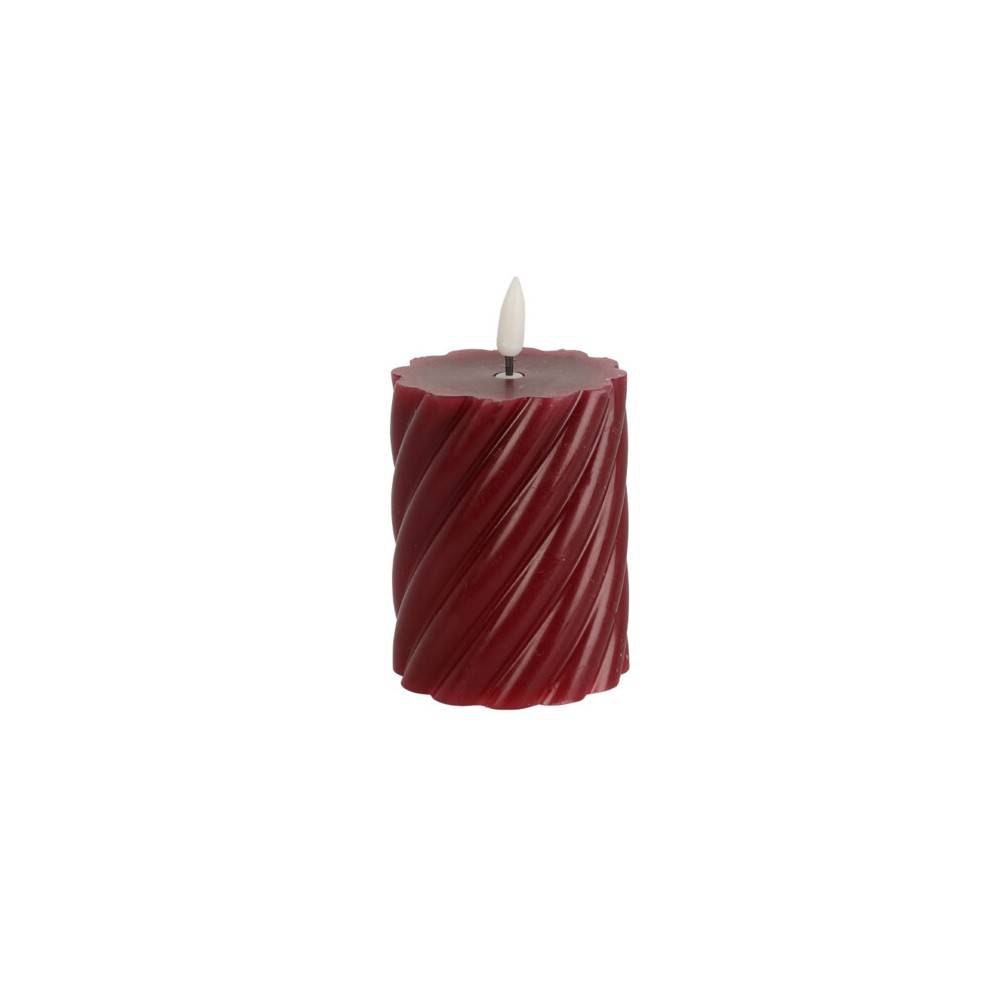 A deep red candle with a twisted texture and a small white wick on top.