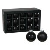 A stylish box contains shiny and matte black Christmas ornaments.