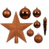 A collection of shiny, metallic bronze holiday ornaments, including a star and various baubles.