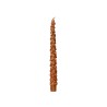 A tall, slender candle shaped like a pine tree, shimmering in warm copper tones.