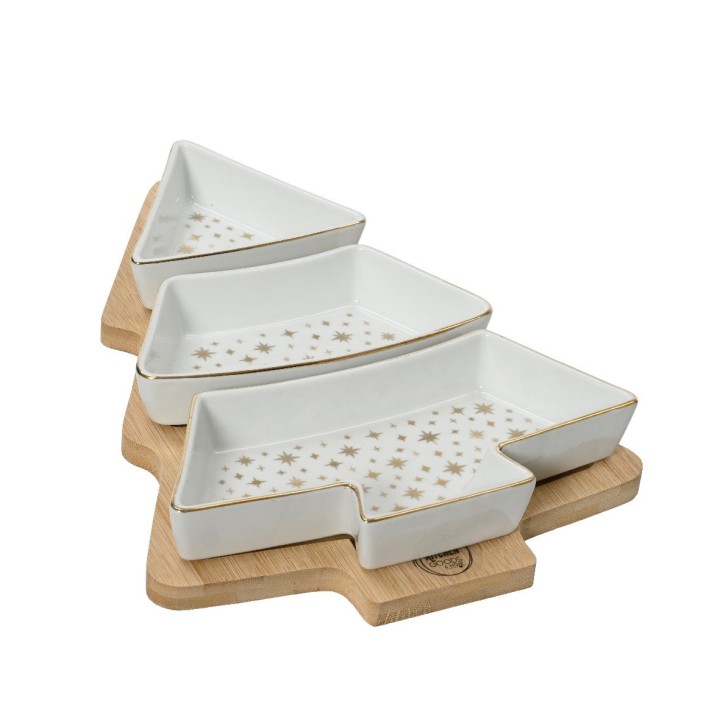 Drie witte serveerschalen in dennenboomvorm op een houten plank, versierd met gouden sterretjes.
