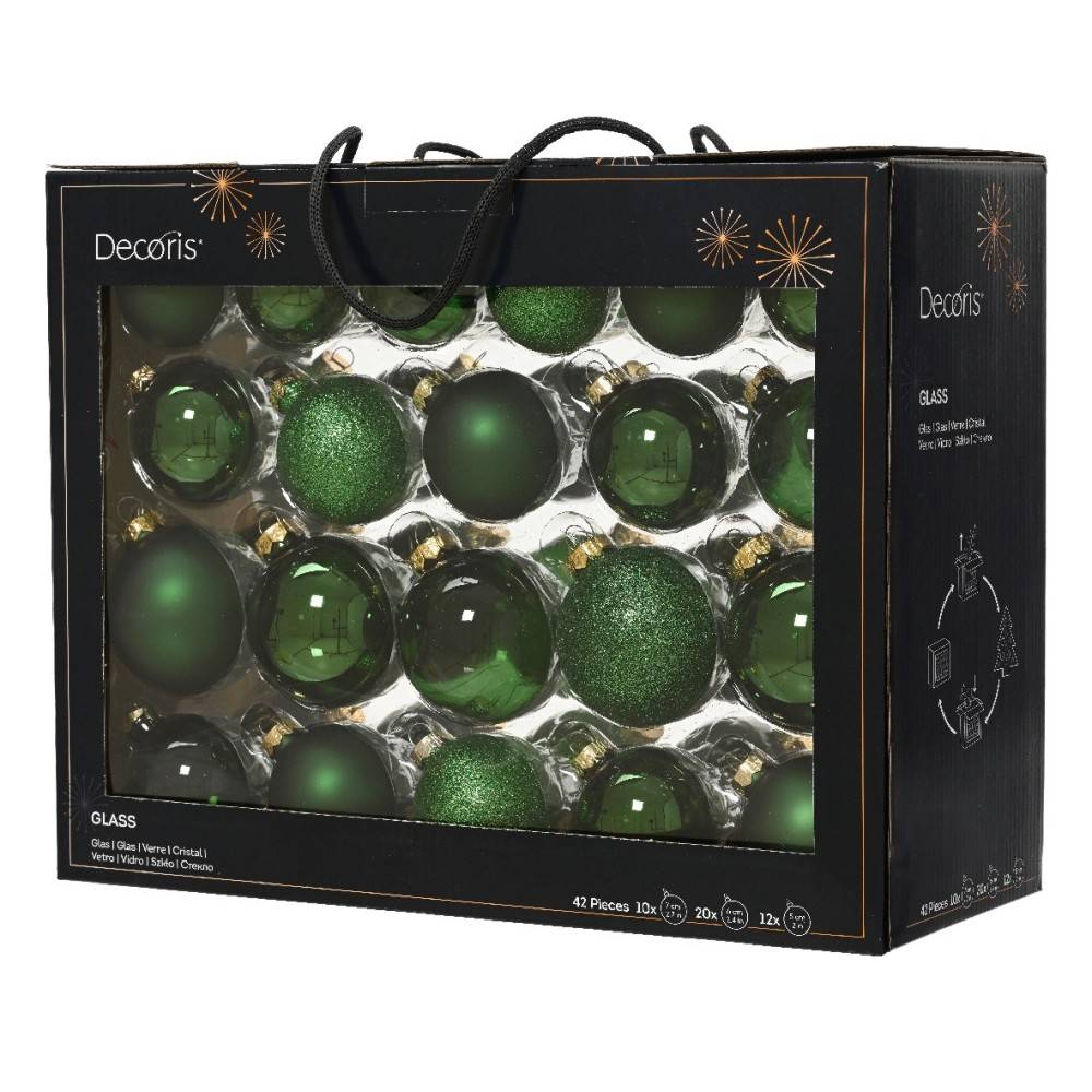 A box filled with shiny green glass Christmas ornaments in various shapes and textures.