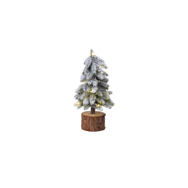 Klein, besneeuwd kerstboompje op een houten stam, met warme lichtjes.