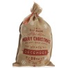 A festive burlap sack with red lettering and snowflakes, marked for Christmas gifts.