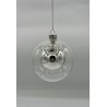 A shiny, silver Christmas ornament with a spherical glass design, suspended by a thin string.