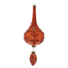 A vibrant red decorative ornament with intricate floral patterns and elegant shapes.