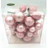 A clear box filled with various pink, glossy, spherical ornaments.
