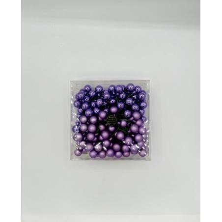 A clear container filled with various shades of purple decorative balls.