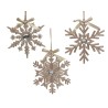 Three shimmering snowflake ornaments in gold and silver, adorned with ribbons and gems.