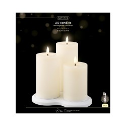 A serene set of three white LED candles on a circular base, mimicking real flames.