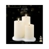 A serene set of three white LED candles on a circular base, mimicking real flames.
