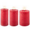 Three tall, textured red candles with gentle flames flickering on top.
